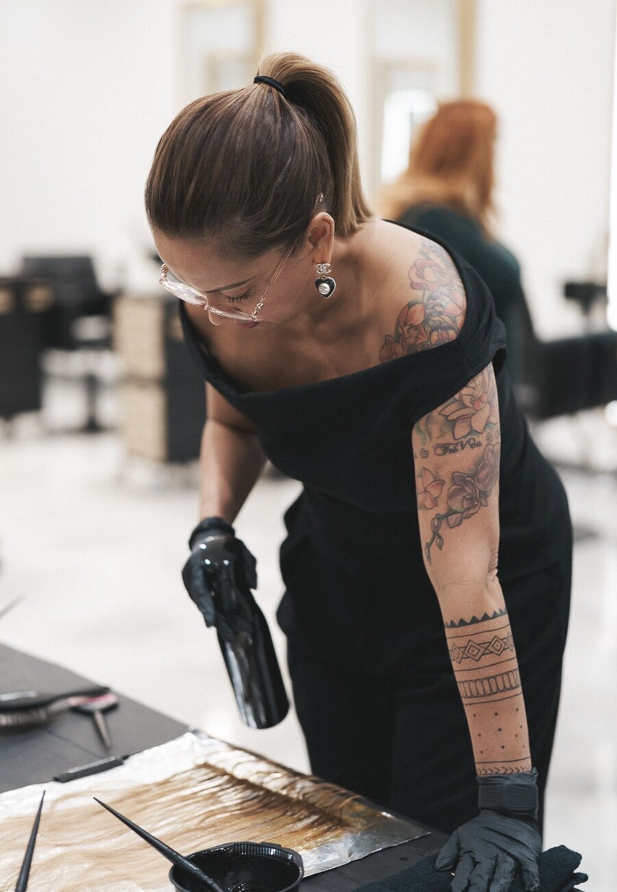 Chanel painting colour onto a board of hair