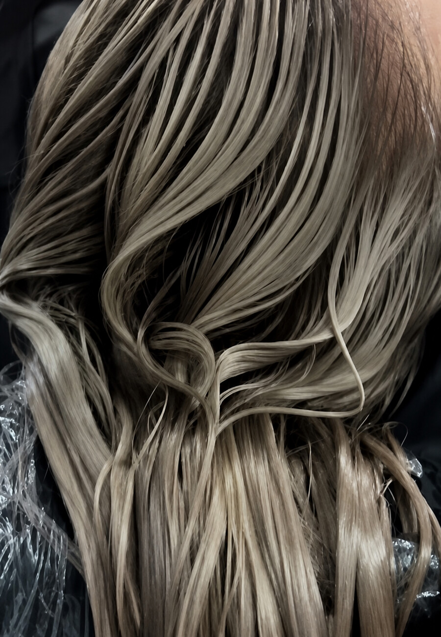 Hair lifted from dark to a soft cool blonde