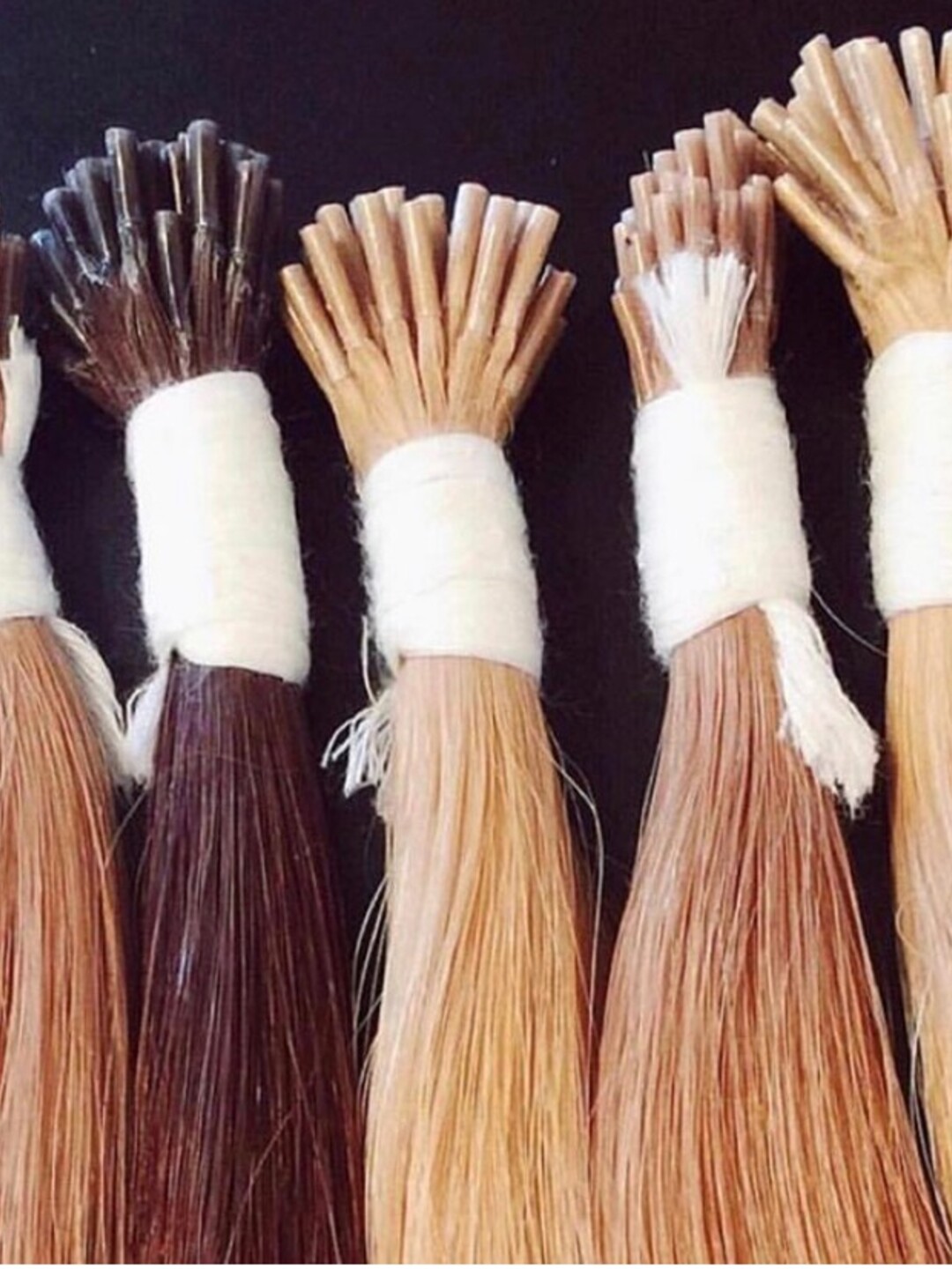 Five MONTI wefts, dark brown through light blonde, bound and ready