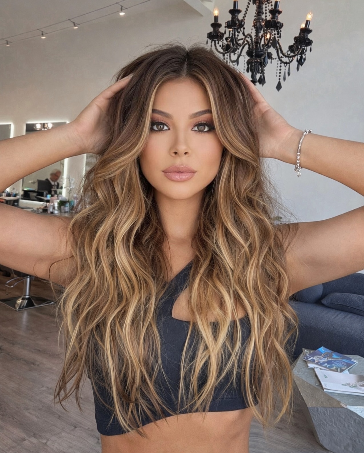 A client with long caramel-colored waves at European Touch Hair Design
