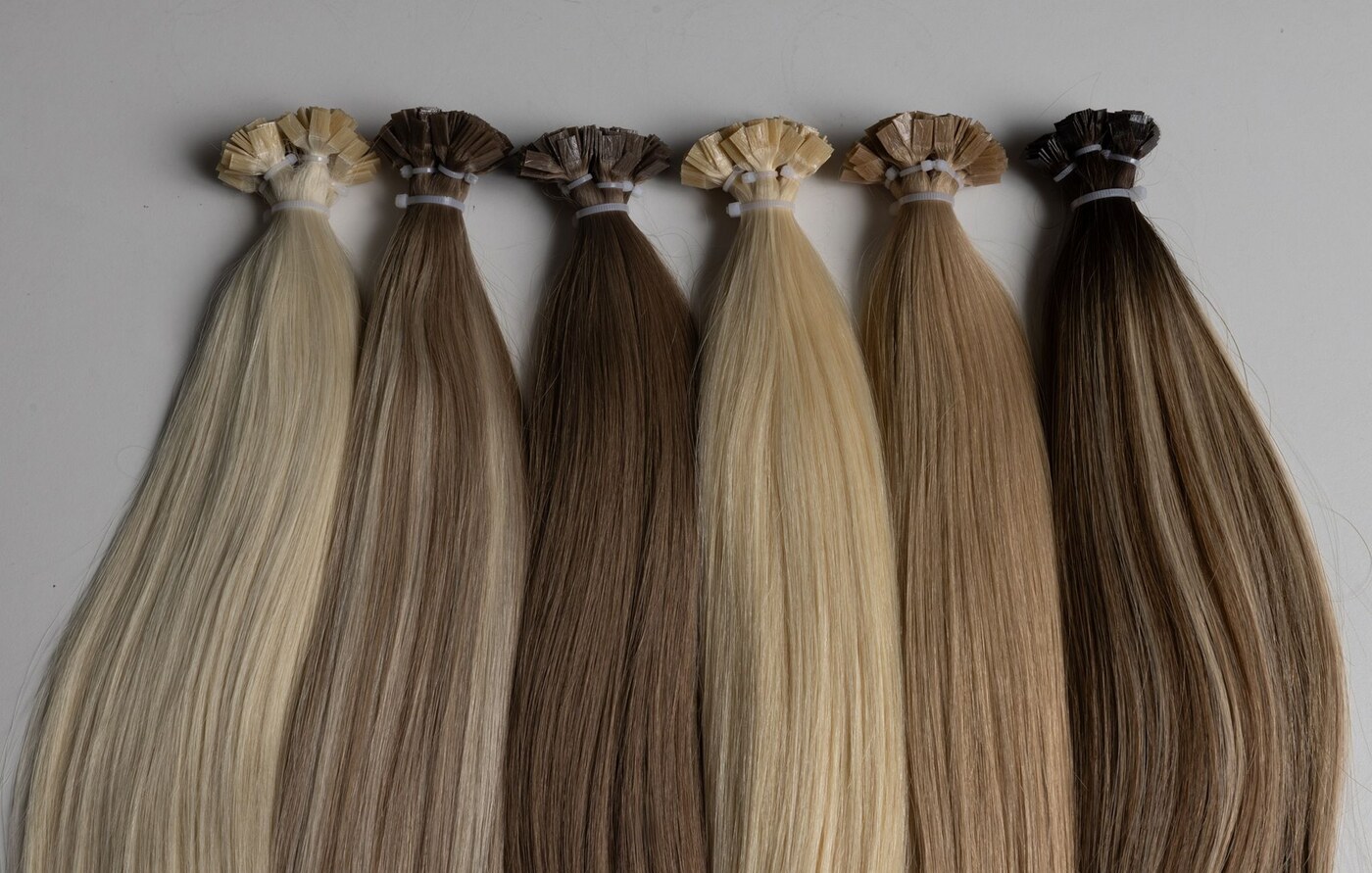 Keratin-bonded extension strands laid out in a fan of shades