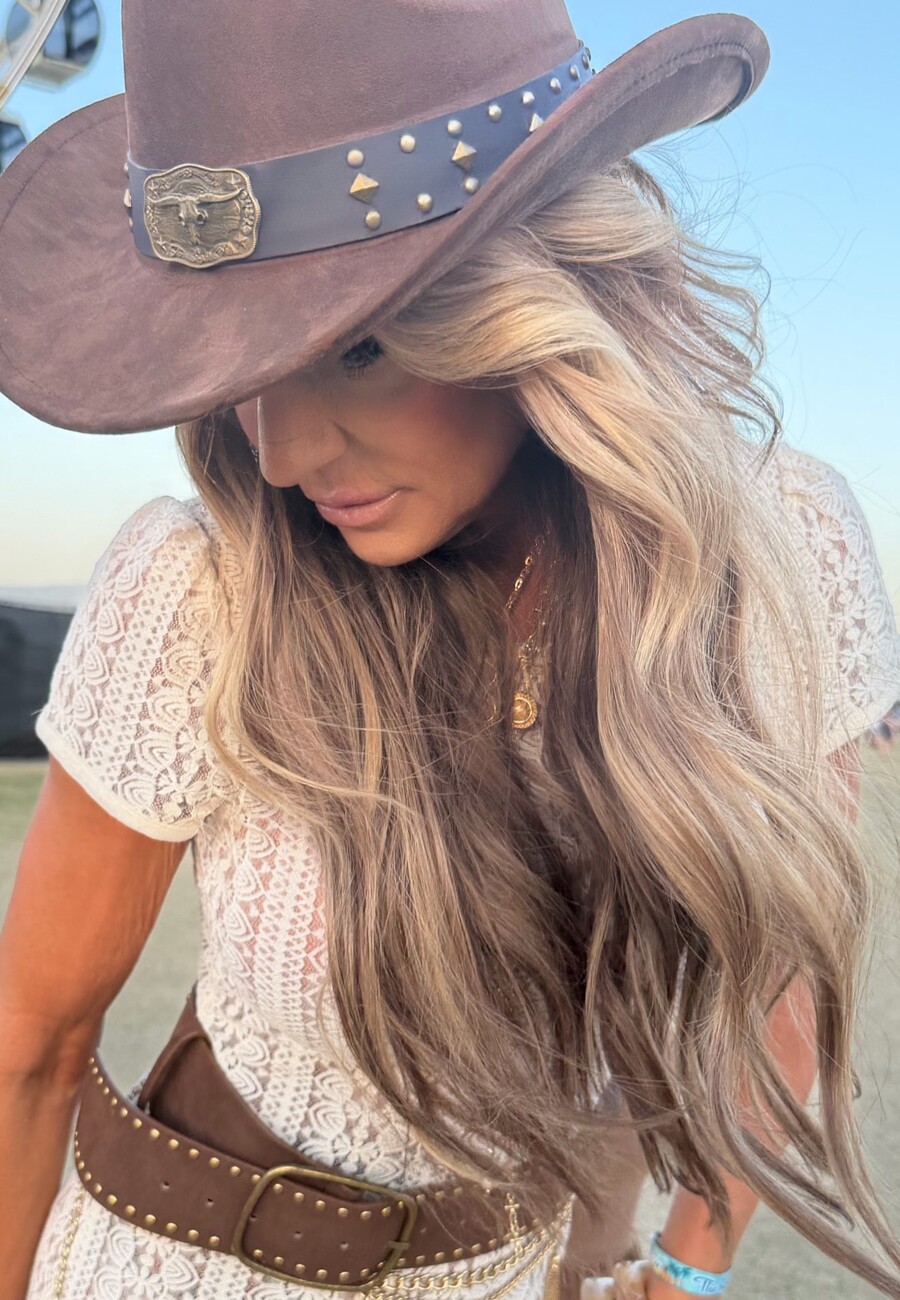 Sun-lit blonde waves under a hat