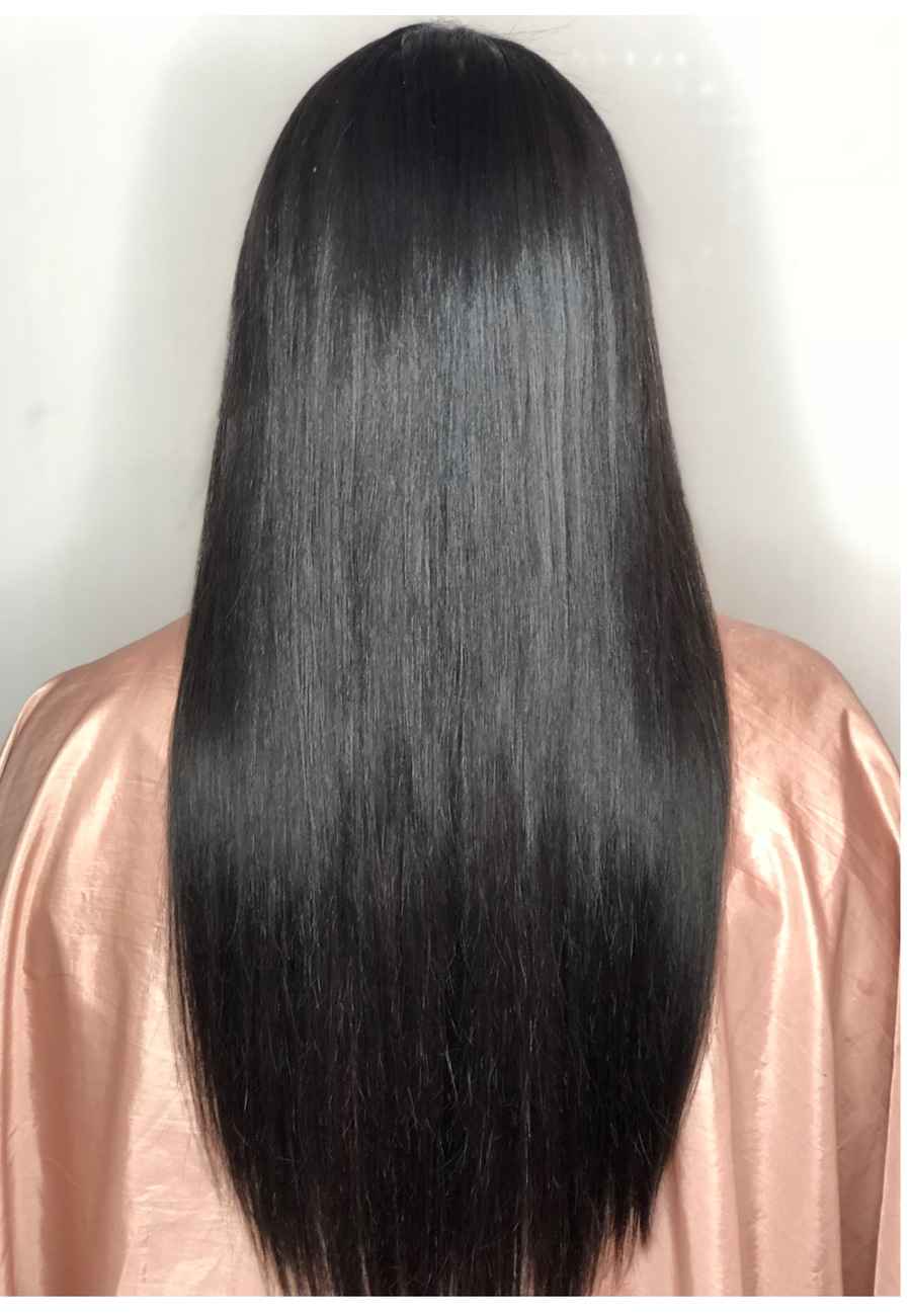 Jet-black hair worn poker straight to the waist, over a rose satin cape
