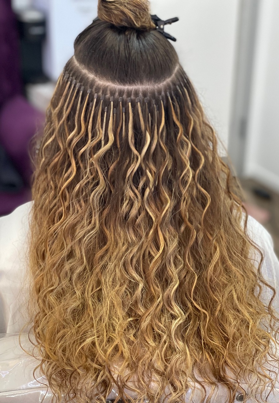 A full head of keratin bonds, photographed with the top section still clipped up