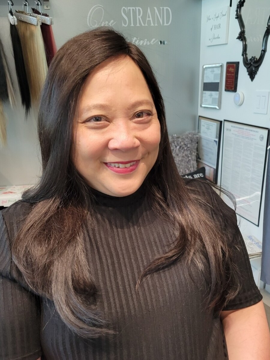 Long, full dark hair past the shoulders, after