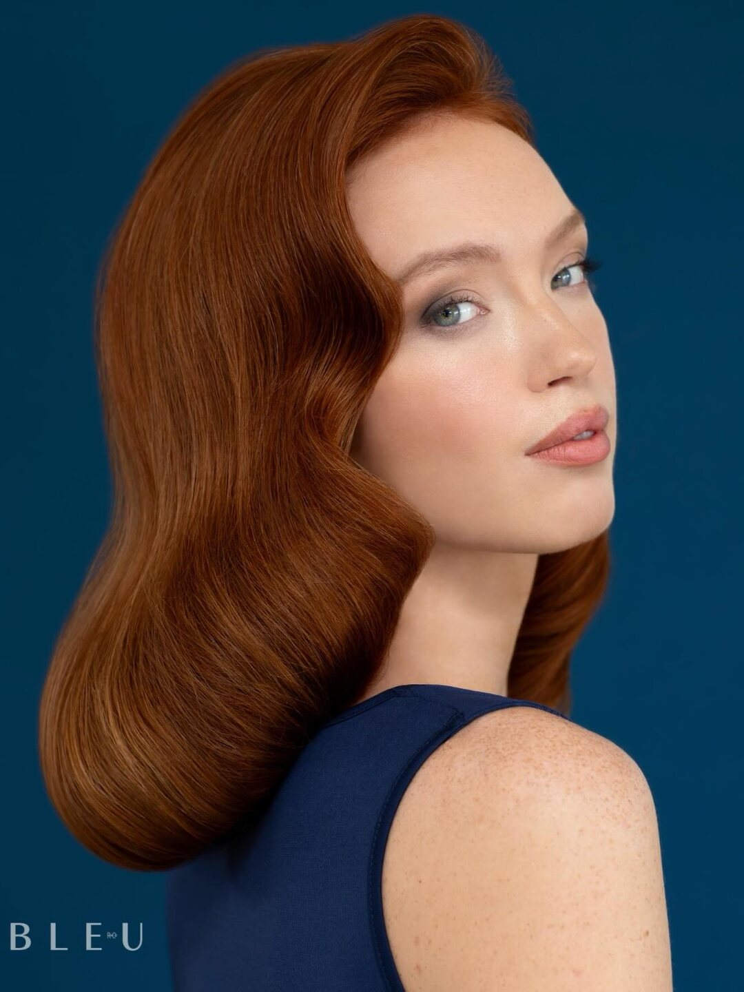 Glossy copper waves against a deep blue backdrop