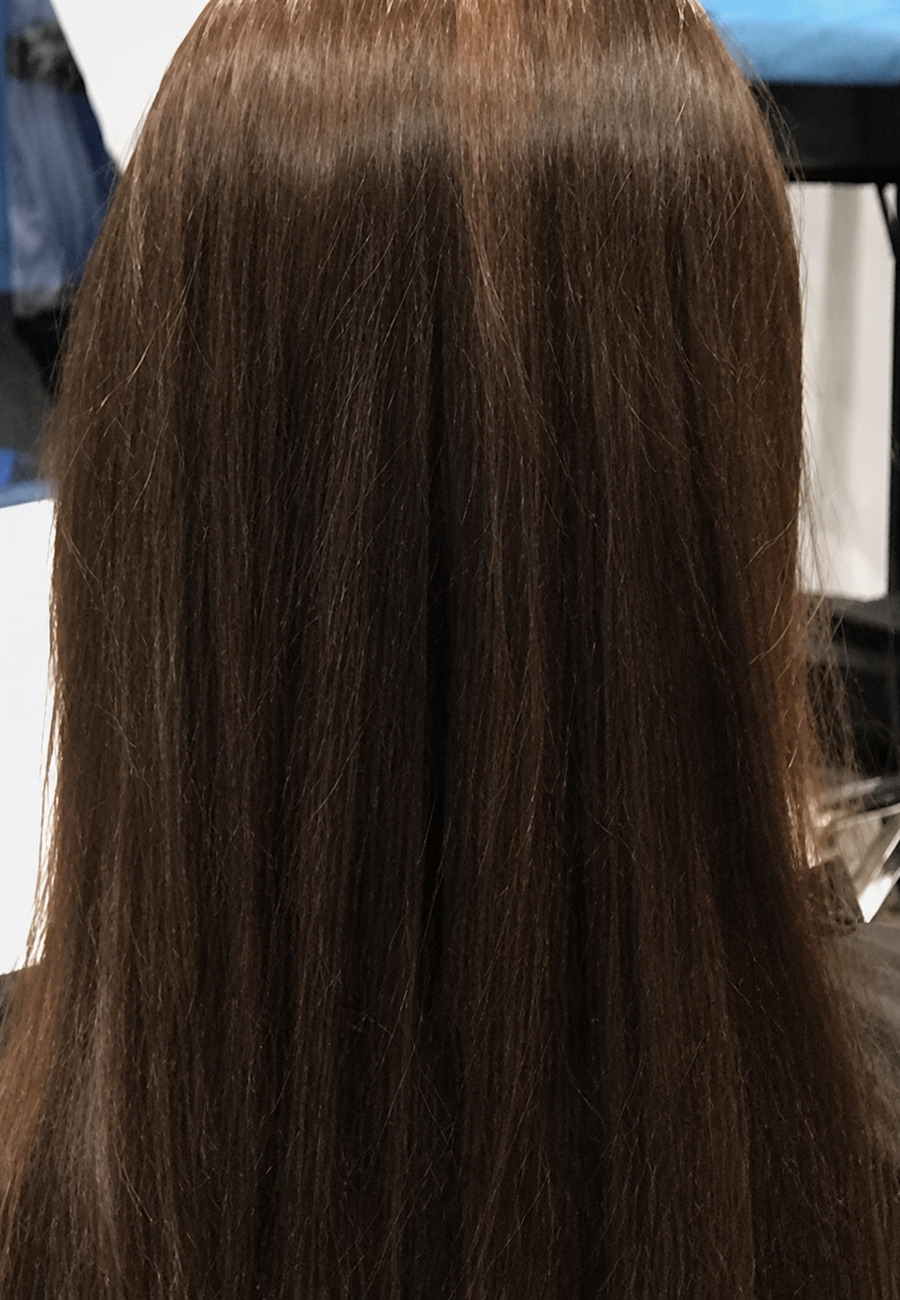 Before: straight brunette hair photographed from behind