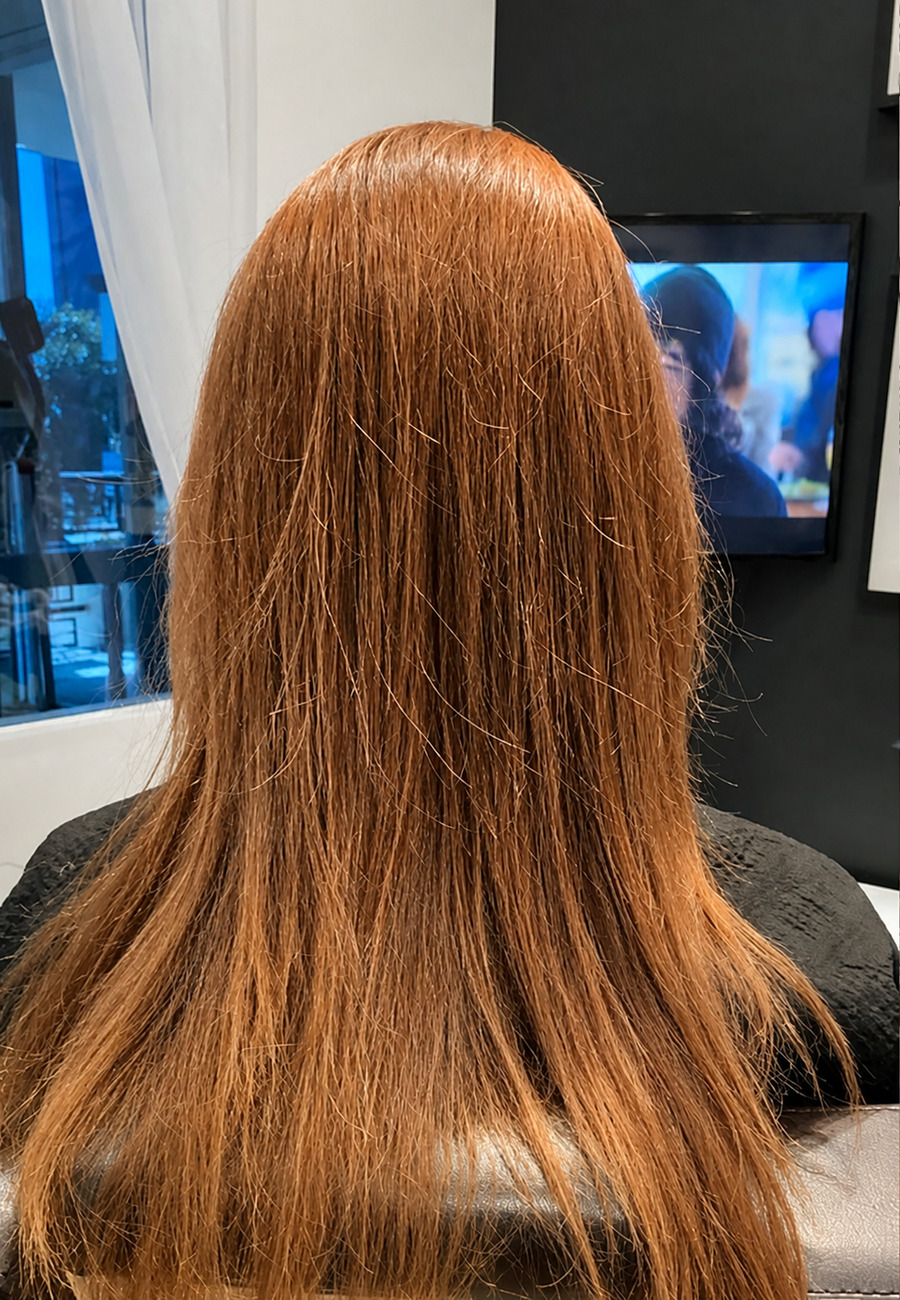 Before: straight copper hair photographed in the salon
