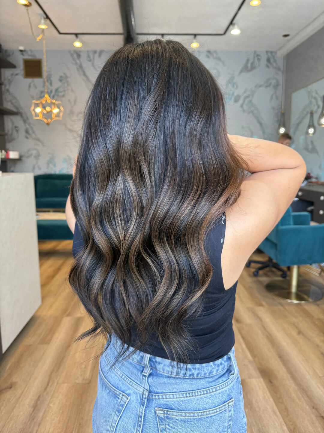 Long dark brunette hair, waved, from behind