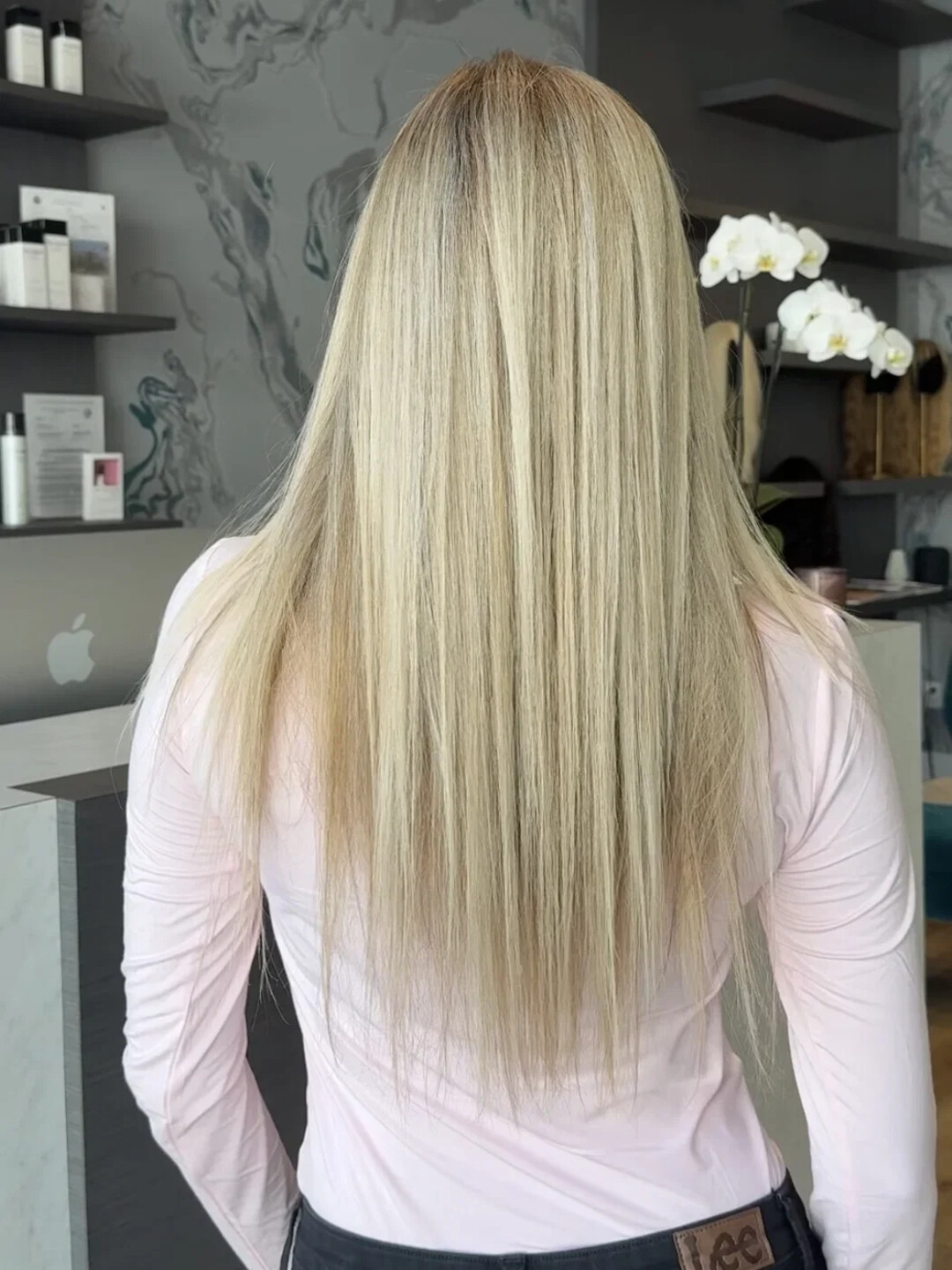 Long straight blonde hair, worn down, from behind