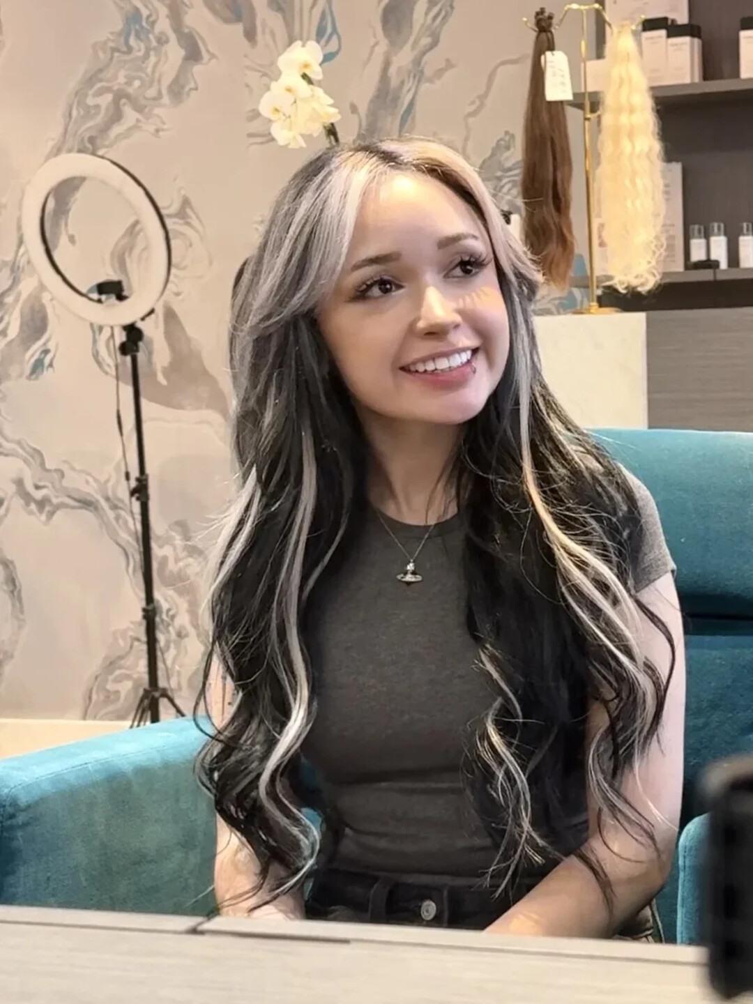Dark hair with a silver money piece, worn down